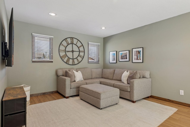 living area featuring wood finished floors, baseboards, and recessed lighting