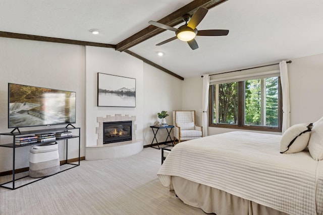 bedroom with a glass covered fireplace, baseboards, carpet, and ceiling fan