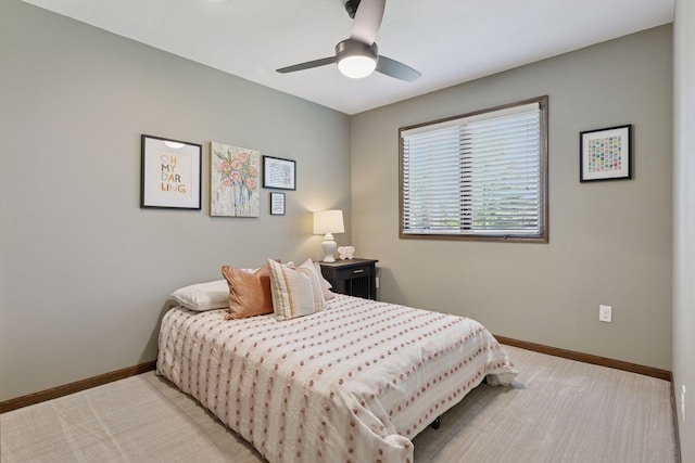 bedroom with baseboards, light carpet, and a ceiling fan