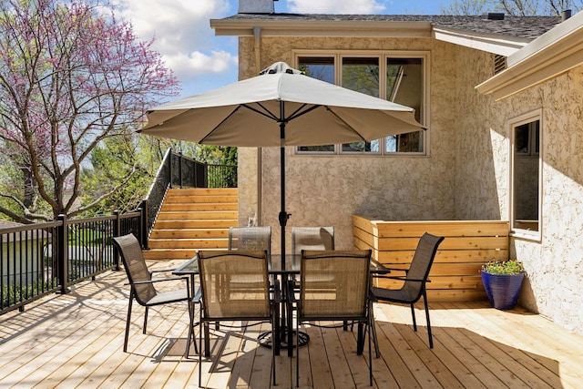 wooden deck with stairway and outdoor dining area