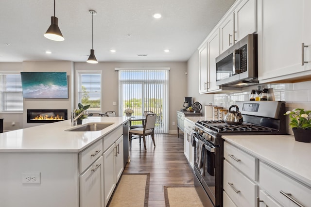 1836 Tyrone Dr, Shakopee, MN 55379 - kitchen with stainless steel appliances, light countertops, wood finished floors, white cabinets, and recessed lighting