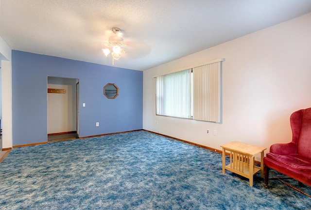 624 Main St, West Concord, MN 55985 - living area with ceiling fan, carpet, and baseboards