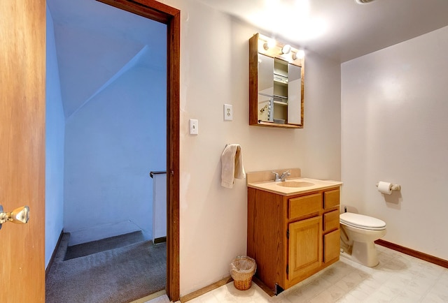 624 Main St, West Concord, MN 55985 - bathroom with vanity, toilet, and baseboards