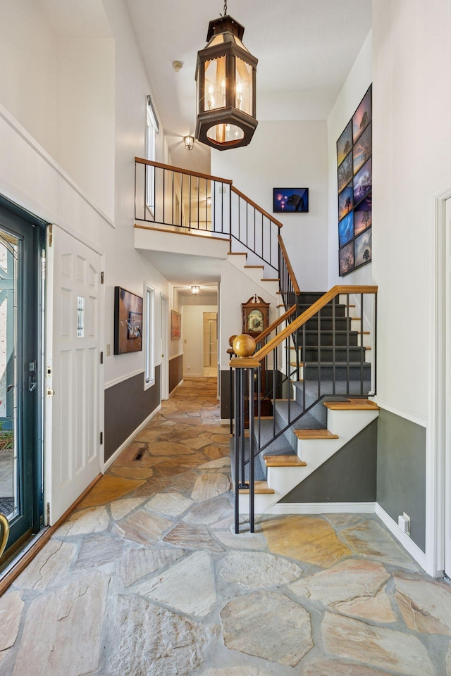 5510 Heather Dr SW, Rochester Twp, MN 55902 - foyer with stone flooring, stairway, baseboards, and a high ceiling