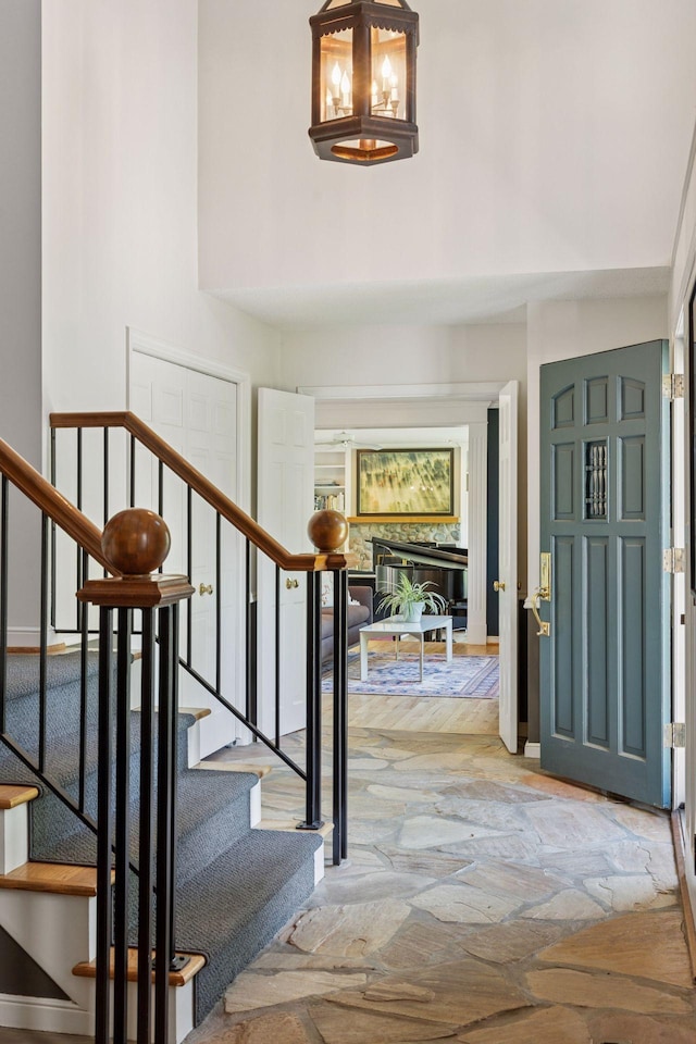 5510 Heather Dr SW, Rochester Twp, MN 55902 - foyer entrance with stone floors, a high ceiling, and stairway