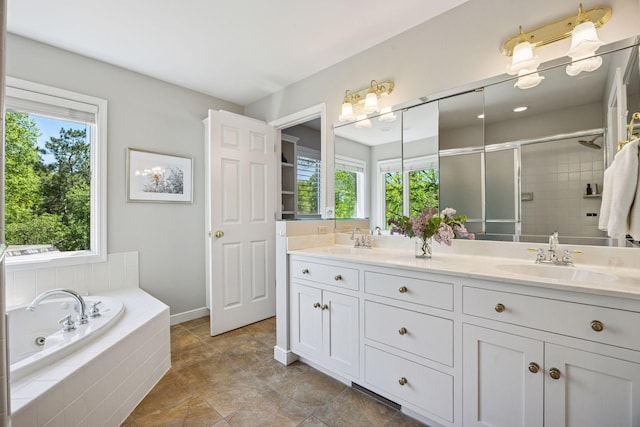 5510 Heather Dr SW, Rochester Twp, MN 55902 - full bathroom with double vanity, a shower stall, a garden tub, and baseboards