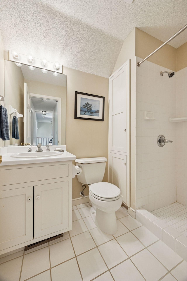 5510 Heather Dr SW, Rochester Twp, MN 55902 - full bathroom with a tile shower, toilet, vanity, tile patterned flooring, and a textured ceiling