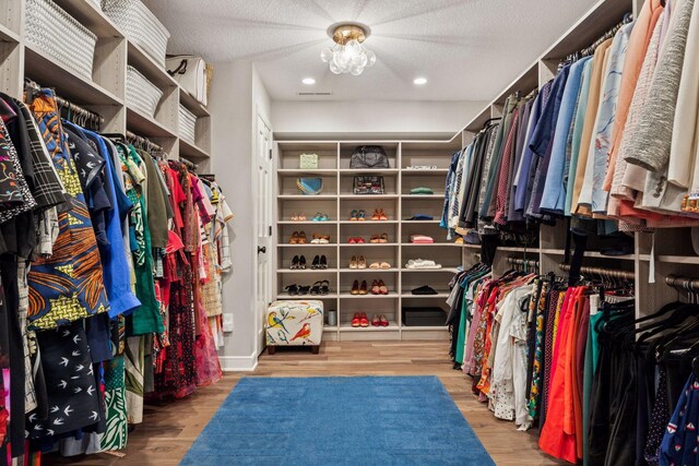 5510 Heather Dr SW, Rochester Twp, MN 55902 - walk in closet featuring wood finished floors