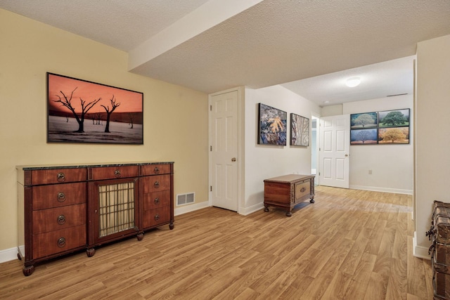 5510 Heather Dr SW, Rochester Twp, MN 55902 - sitting room with light wood-type flooring, baseboards, and a textured ceiling
