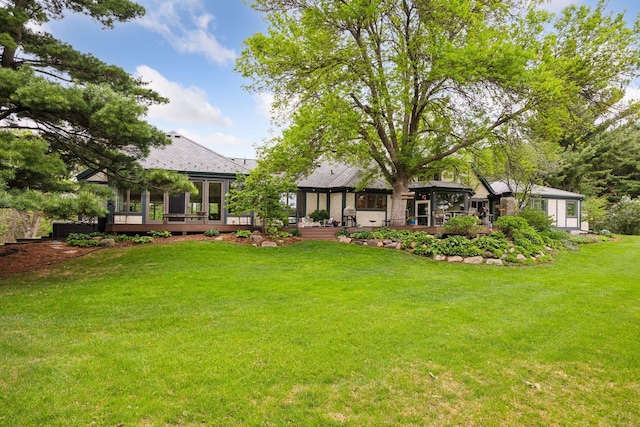 5510 Heather Dr SW, Rochester Twp, MN 55902 - view of green lawn with a wooden deck and a sunroom