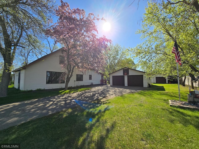 12115 Ramsey St, Becker, MN 55308 - view of property exterior with an outdoor structure, a detached garage, and a yard