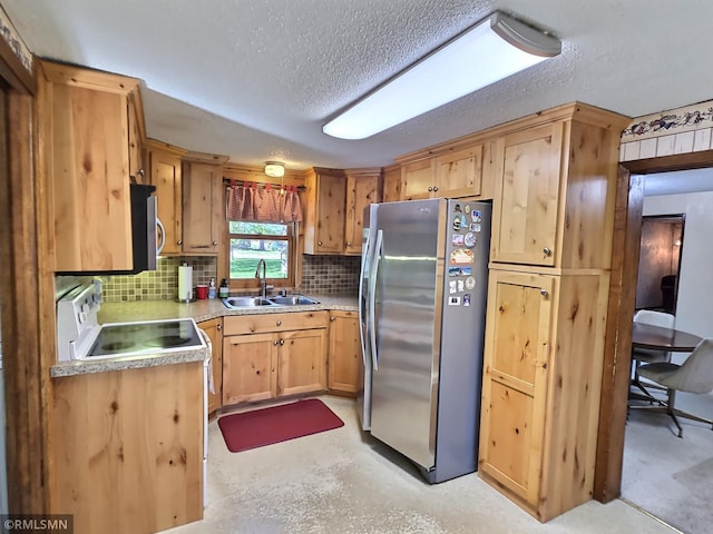 12115 Ramsey St, Becker, MN 55308 - kitchen featuring stainless steel appliances, a sink, a textured ceiling, backsplash, and light countertops