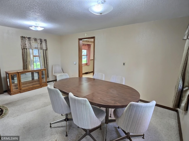 12115 Ramsey St, Becker, MN 55308 - carpeted dining space featuring a textured ceiling and baseboards