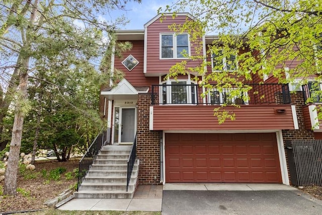 view of front of property with a garage, brick siding, and driveway