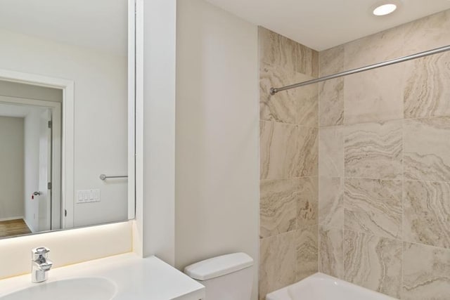 full bath with toilet, vanity, and shower / washtub combination
