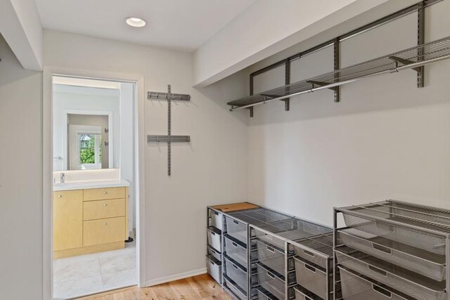 spacious closet featuring light wood-style flooring
