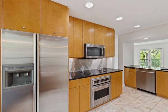 kitchen featuring stainless steel appliances, recessed lighting, dark countertops, backsplash, and brown cabinets