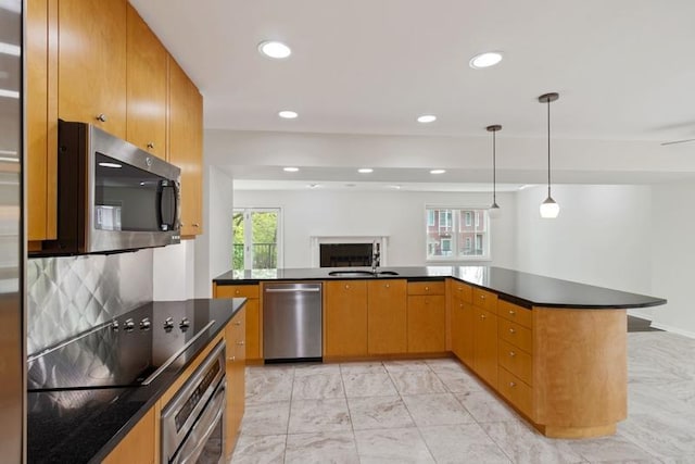 kitchen featuring appliances with stainless steel finishes, dark countertops, recessed lighting, decorative light fixtures, and backsplash
