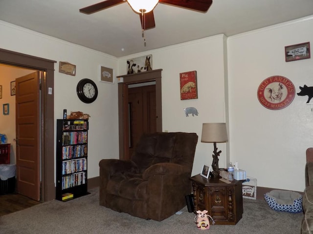 carpeted living area featuring a ceiling fan and crown molding