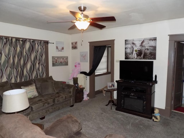 carpeted living area featuring a ceiling fan and crown molding