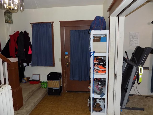 interior space with radiator heating unit and a chandelier