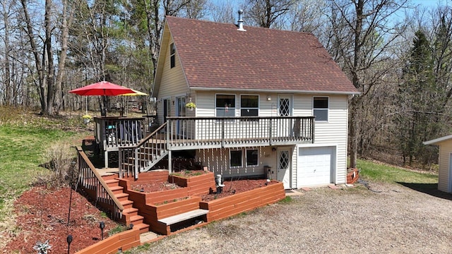 25185 Moreau Rd, Aitkin, MN 56431 - view of front of house with an attached garage, a wooden deck, a shingled roof, and gravel driveway