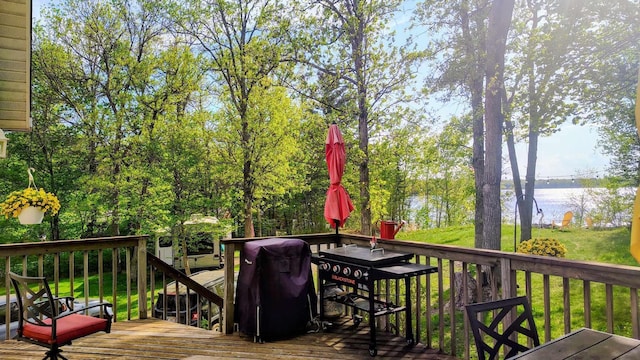 25185 Moreau Rd, Aitkin, MN 56431 - deck featuring a water view, outdoor dining area, and a yard