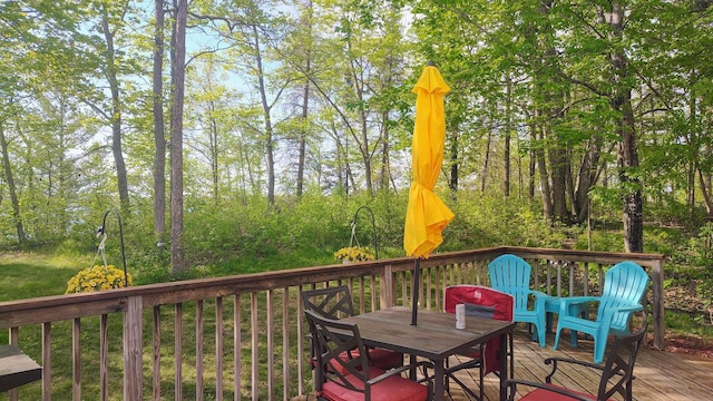 25185 Moreau Rd, Aitkin, MN 56431 - wooden terrace with outdoor dining area
