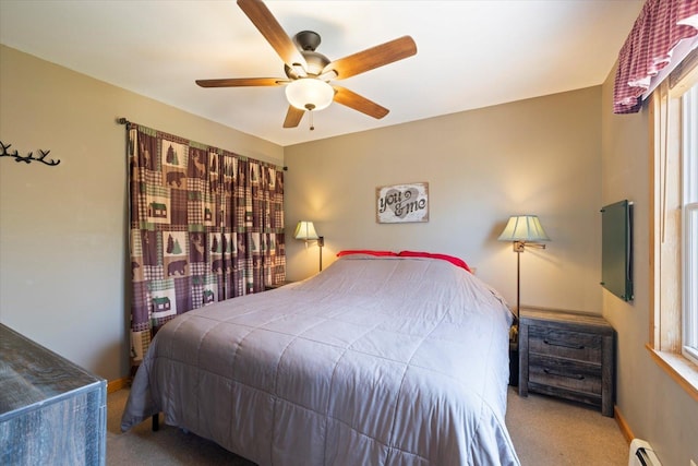 25185 Moreau Rd, Aitkin, MN 56431 - bedroom with a baseboard heating unit, carpet flooring, a ceiling fan, and multiple windows