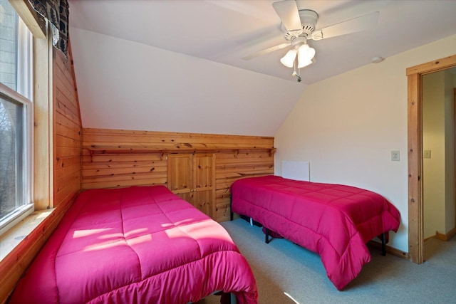 25185 Moreau Rd, Aitkin, MN 56431 - bedroom featuring carpet floors, wooden walls, vaulted ceiling, and ceiling fan