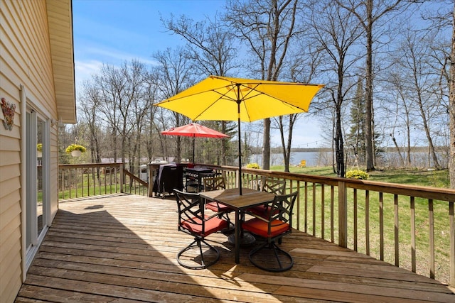 25185 Moreau Rd, Aitkin, MN 56431 - wooden terrace with outdoor dining area and a water view