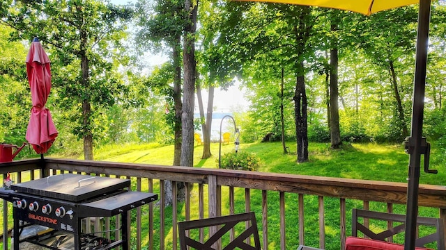 25185 Moreau Rd, Aitkin, MN 56431 - wooden terrace featuring a lawn and grilling area