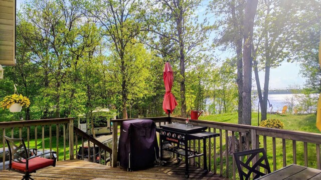 25185 Moreau Rd, Aitkin, MN 56431 - deck with a water view, outdoor dining space, and a lawn