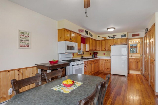 25185 Moreau Rd, Aitkin, MN 56431 - kitchen featuring white appliances, wood-type flooring, and tasteful backsplash