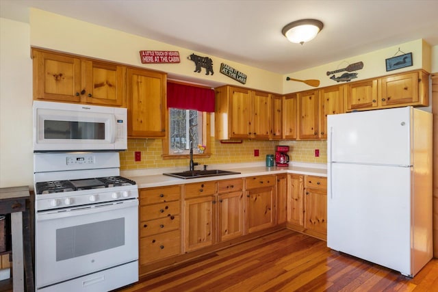 25185 Moreau Rd, Aitkin, MN 56431 - kitchen with white appliances, dark wood-type flooring, light countertops, tasteful backsplash, and brown cabinets