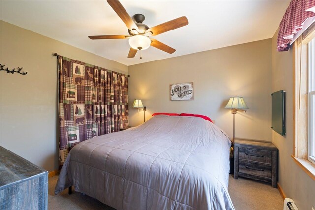 25185 Moreau Rd, Aitkin, MN 56431 - bedroom with a baseboard heating unit, carpet flooring, ceiling fan, and multiple windows