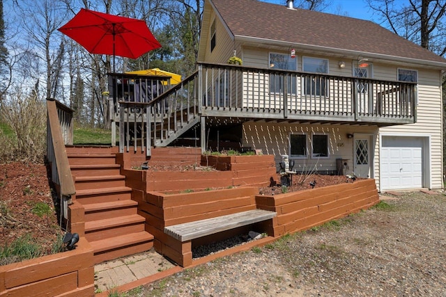 25185 Moreau Rd, Aitkin, MN 56431 - rear view of property with stairway, a shingled roof, a wooden deck, and a garage