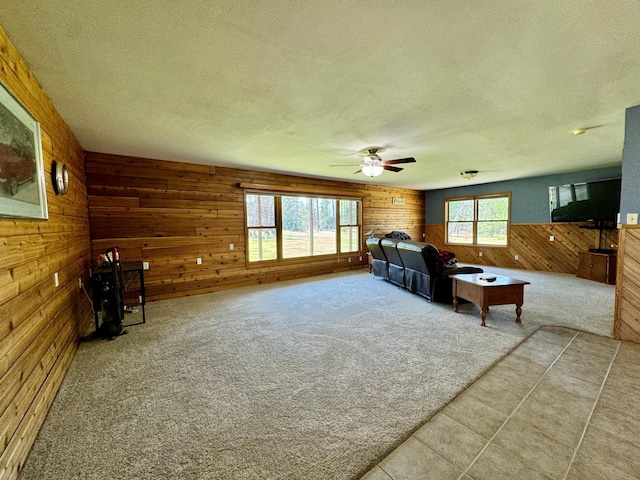 55715 State Highway 11, Warroad, MN 56763 - living area featuring wooden walls, a textured ceiling, ceiling fan, and carpet flooring