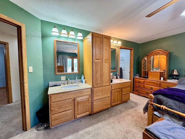 55715 State Highway 11, Warroad, MN 56763 - full bath featuring two vanities, a textured wall, and carpet