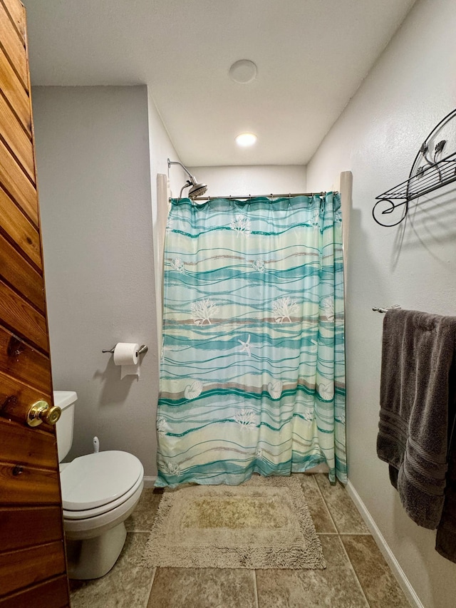 55715 State Highway 11, Warroad, MN 56763 - bathroom with toilet, curtained shower, baseboards, and tile patterned floors