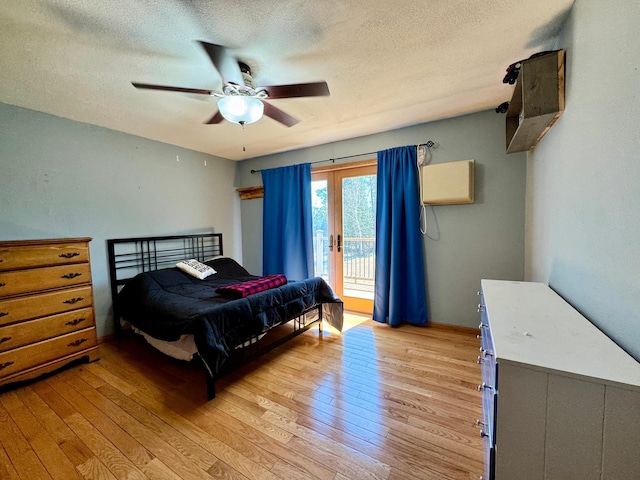 55715 State Highway 11, Warroad, MN 56763 - bedroom featuring access to exterior, light wood-style floors, a textured ceiling, and a ceiling fan