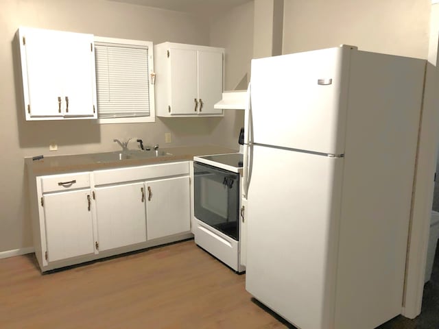55715 State Highway 11, Warroad, MN 56763 - kitchen with freestanding refrigerator, range with electric cooktop, a sink, light wood-style flooring, and white cabinetry