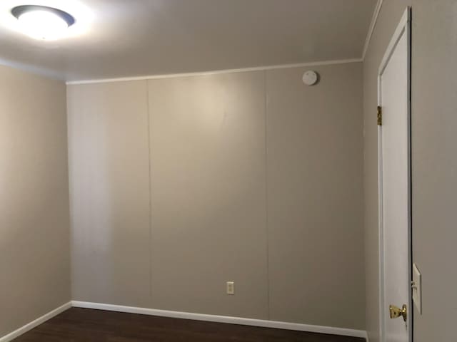 55715 State Highway 11, Warroad, MN 56763 - spare room featuring dark wood-style floors, baseboards, crown molding, and a smoke detector