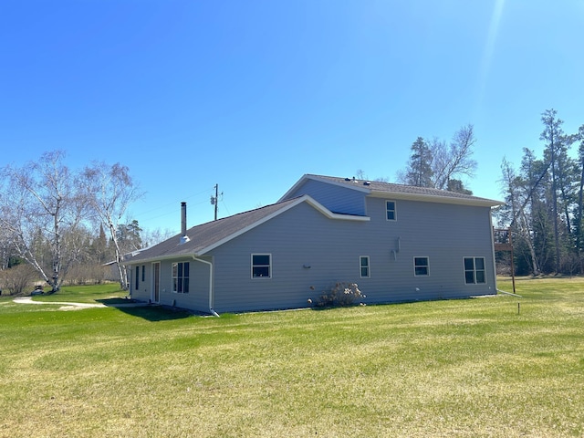 55715 State Highway 11, Warroad, MN 56763 - view of side of home featuring a yard and a chimney
