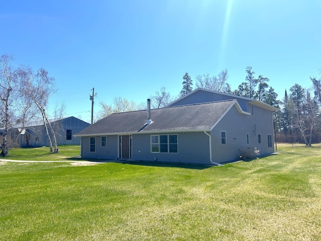 55715 State Highway 11, Warroad, MN 56763 - back of house with a yard and roof with shingles