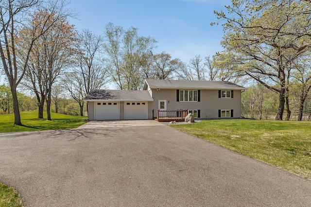 view of front facade featuring asphalt driveway, a garage, a front lawn, and a deck