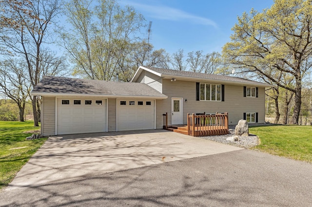 view of front of property with driveway, a garage, a front lawn, and a deck