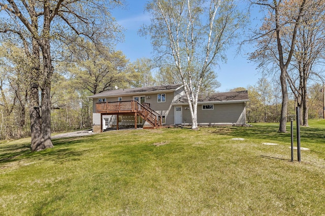 back of property with stairway, a wooden deck, and a yard