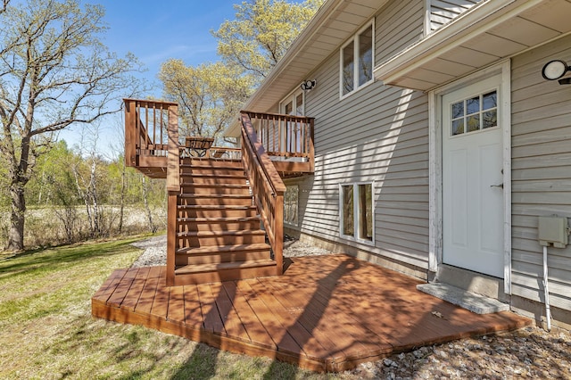 wooden terrace featuring stairway and a lawn