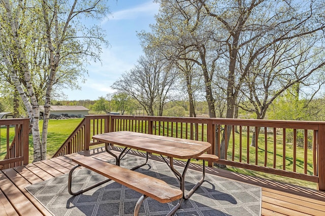 deck featuring a lawn and outdoor dining space